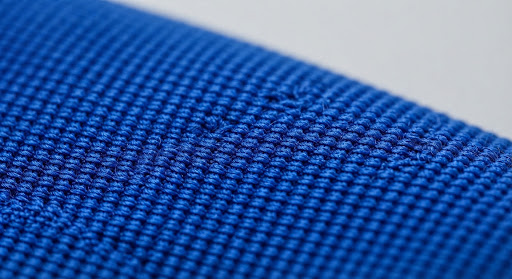Macro view of a durable polyester swimwear fabric.