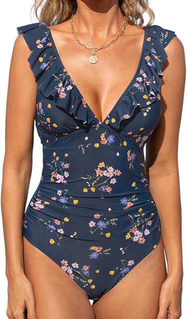 Women's One Piece Swimsuit V Neck Bathing Suit Ruched Tummy | Ruched Waist, Ruffled Trim, Removable Soft Cups, Back Tie Closure, Adjustable Lace Up, Cutout, Standard Coverage A V-neck ruched tummy control swimsuit with cutout details and lace-up back.