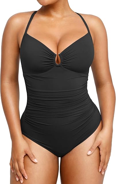 An editorial full-body shot of high-waist bikini bottoms paired with a matching top in a deep charcoal black.